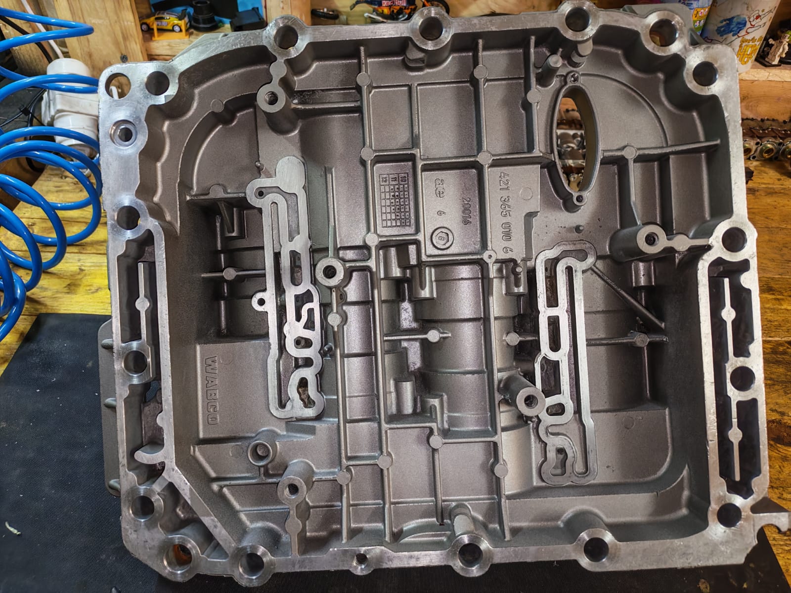 A machined gearbox valve body on the workbench